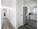 Hallway view leading to a kitchen with stainless steel appliances and wood flooring at 319 Honeysuckle Ter, Auburn, GA 30011