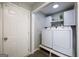 Efficient laundry space with modern Samsung appliances, cabinets, and gray flooring at 319 Honeysuckle Ter, Auburn, GA 30011