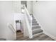 Stairway leading to the upper level, adjacent to the laundry area with modern appliances at 319 Honeysuckle Ter, Auburn, GA 30011