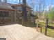 A beautiful home exterior featuring a wooden deck with railings, showcasing a stone wall exterior, adding character and charm to the property at 3314 Henson Ln, Stockbridge, GA 30281