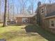 Spacious backyard featuring a deck area connecting to the stone and brick sections of the home's exterior at 3314 Henson Ln, Stockbridge, GA 30281