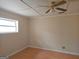 This bedroom features natural light, with a ceiling fan, neutral paint, hardwood flooring, and a window for a bright and airy feel at 3314 Henson Ln, Stockbridge, GA 30281