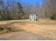 Backyard greenhouse with natural light and white trim amid natural surroundings on a clear day at 3314 Henson Ln, Stockbridge, GA 30281