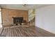Living room with brick fireplace and hardwood flooring at 3314 Henson Ln, Stockbridge, GA 30281