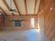 This living room showcases exposed wood beams, a brick fireplace, and ample natural light, creating a cozy and inviting atmosphere at 3314 Henson Ln, Stockbridge, GA 30281