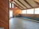 Spacious living room with wood-paneled walls and ceiling, a tiled floor, and large windows allowing plenty of natural light to fill the room at 3314 Henson Ln, Stockbridge, GA 30281