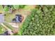 Aerial view of the brick home surrounded by mature trees and lush greenery on a well manicured lot at 205 Wynnfield Way, Mcdonough, GA 30252