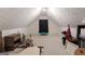 Spacious carpeted attic room with neutral walls, window, and plenty of room for storage or other uses at 205 Wynnfield Way, Mcdonough, GA 30252