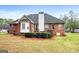 Brick home featuring a spacious backyard with a patio, perfect for outdoor enjoyment at 205 Wynnfield Way, Mcdonough, GA 30252
