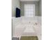 Bathroom features a large bathtub with tile surround and natural light at 205 Wynnfield Way, Mcdonough, GA 30252