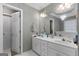 Bathroom with double vanity, a large mirror, and a door to the hallway at 205 Wynnfield Way, Mcdonough, GA 30252