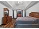 Primary bedroom with wood floors, tray ceiling, and lots of natural light at 205 Wynnfield Way, Mcdonough, GA 30252