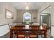 Dining room with hardwood floors, large window view of the property, and classic wooden table at 205 Wynnfield Way, Mcdonough, GA 30252