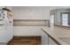 Spacious kitchen with white cabinets and hardwood flooring, providing ample storage and workspace at 205 Wynnfield Way, Mcdonough, GA 30252