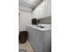 Bright laundry room featuring white cabinets and modern washer and dryer units at 205 Wynnfield Way, Mcdonough, GA 30252