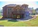 View of the multi-level deck and stone staircase leading up to the brick home and lush, green backyard at 65 Lotus Ln, Covington, GA 30016