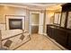 Bathroom featuring a soaking tub, fireplace, double vanity with marble top, and tile flooring at 65 Lotus Ln, Covington, GA 30016