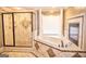 Luxurious bathroom featuring a soaking tub, fireplace, and a large glass shower at 65 Lotus Ln, Covington, GA 30016