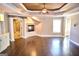 Large bonus room featuring a tray ceiling, fireplace, and hardwood floors at 65 Lotus Ln, Covington, GA 30016