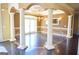 Dining room featuring a chandelier, wainscoting, and columns at 65 Lotus Ln, Covington, GA 30016