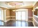 Dining room with hardwood floors, wainscoting, and a modern chandelier for elegant dining at 65 Lotus Ln, Covington, GA 30016