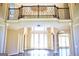 Grand foyer boasts a soaring ceiling, iron railing, and marble flooring at 65 Lotus Ln, Covington, GA 30016