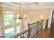 Open hallway with wrought iron railing, large windows, and natural light at 65 Lotus Ln, Covington, GA 30016
