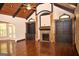 Open-concept living space featuring a fireplace, built-in shelving, hardwood floors, and high ceilings at 65 Lotus Ln, Covington, GA 30016