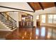 Spacious living room with hardwood floors, staircase, and open access to the modern kitchen area at 65 Lotus Ln, Covington, GA 30016