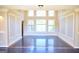 Spacious living room boasts high ceilings, large windows, and beautiful hardwood floors at 65 Lotus Ln, Covington, GA 30016