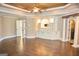 Open living room with built-in storage and shelving; hardwood flooring, and adjacent bathroom access at 65 Lotus Ln, Covington, GA 30016