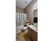 Bathroom featuring a shower with patterned curtain, neutral walls, and single sink vanity at 128 Astilbe Meadow Dr, Locust Grove, GA 30248