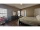 Cozy bedroom boasting wood floors, a dresser, and natural light from large windows at 128 Astilbe Meadow Dr, Locust Grove, GA 30248