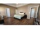 Comfortable bedroom featuring wood floors, ceiling fan, and multiple closets at 128 Astilbe Meadow Dr, Locust Grove, GA 30248