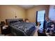 Comfortable bedroom with patterned bedding, plush pillows, natural light, and a TV at 128 Astilbe Meadow Dr, Locust Grove, GA 30248