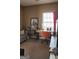 Cozy living room featuring neutral walls, carpet, large window, and comfortable furniture at 128 Astilbe Meadow Dr, Locust Grove, GA 30248