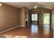 Spacious living room showcasing a fireplace, wood floors, and access to the outdoors at 128 Astilbe Meadow Dr, Locust Grove, GA 30248