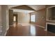 Bright living room featuring hardwood floors, vaulted ceilings, and a cozy fireplace at 128 Astilbe Meadow Dr, Locust Grove, GA 30248