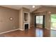 Comfortable living room with a cozy fireplace, neutral walls, and plenty of natural light at 128 Astilbe Meadow Dr, Locust Grove, GA 30248