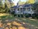 Charming home featuring lush landscaping, mature trees, and traditional curb appeal at 5147 Highpoint Rd, Union City, GA 30291