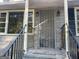 The front porch features a secure front door, railing, and is freshly painted at 5147 Highpoint Rd, Union City, GA 30291