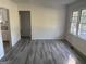 Open living room features new flooring and ample light from the large windows at 5147 Highpoint Rd, Union City, GA 30291