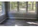 Bright living room area with many windows and luxury vinyl plank flooring at 5147 Highpoint Rd, Union City, GA 30291