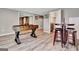 Finished basement boasts a foosball table, seating, and doorway to a room with a refreshment station at 100 Smokerise Trce, Peachtree City, GA 30269