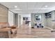 Finished basement boasts updated floors, a comfortable armchair, and an open floor plan at 100 Smokerise Trce, Peachtree City, GA 30269