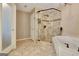 Elegant bathroom featuring tiled shower with glass door and soaking tub with bronze fixtures at 100 Smokerise Trce, Peachtree City, GA 30269