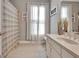 Bathroom featuring a vanity with a sink, a mirror and a window with white curtains at 100 Smokerise Trce, Peachtree City, GA 30269