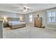 Spacious bedroom featuring a large bed, two dressers, and a ceiling fan at 100 Smokerise Trce, Peachtree City, GA 30269