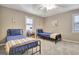 Cozy bedroom with two beds, ceiling fan and natural light at 100 Smokerise Trce, Peachtree City, GA 30269