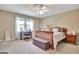 Bright bedroom featuring a comfortable bed, workspace by the window, and ample storage at 100 Smokerise Trce, Peachtree City, GA 30269